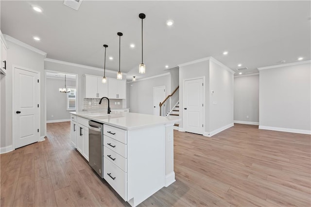 313 Foxglove Way, Mcdonough, GA 30253 - kitchen featuring light countertops, an island with sink, a sink, dishwasher, and ornamental molding