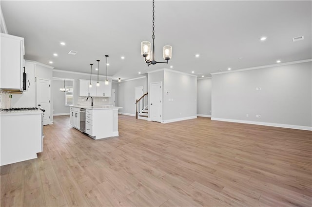 313 Foxglove Way, Mcdonough, GA 30253 - kitchen with recessed lighting, a chandelier, crown molding, open floor plan, and light countertops