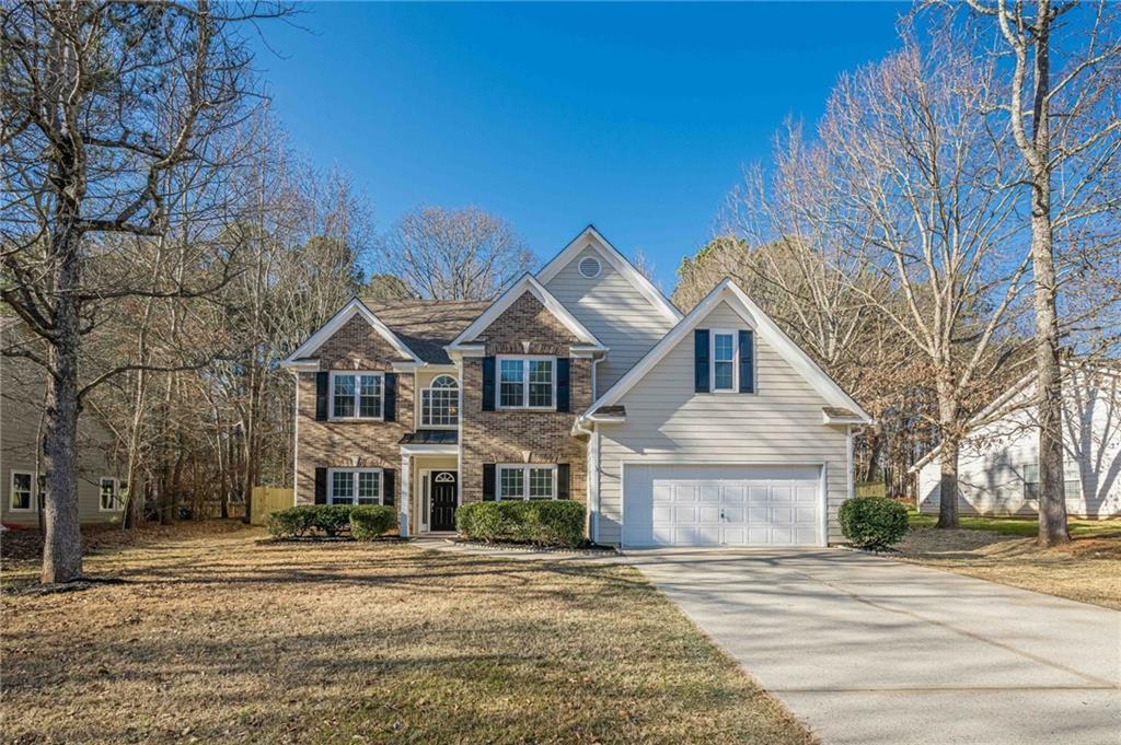 view of front of property with a garage and a front yard