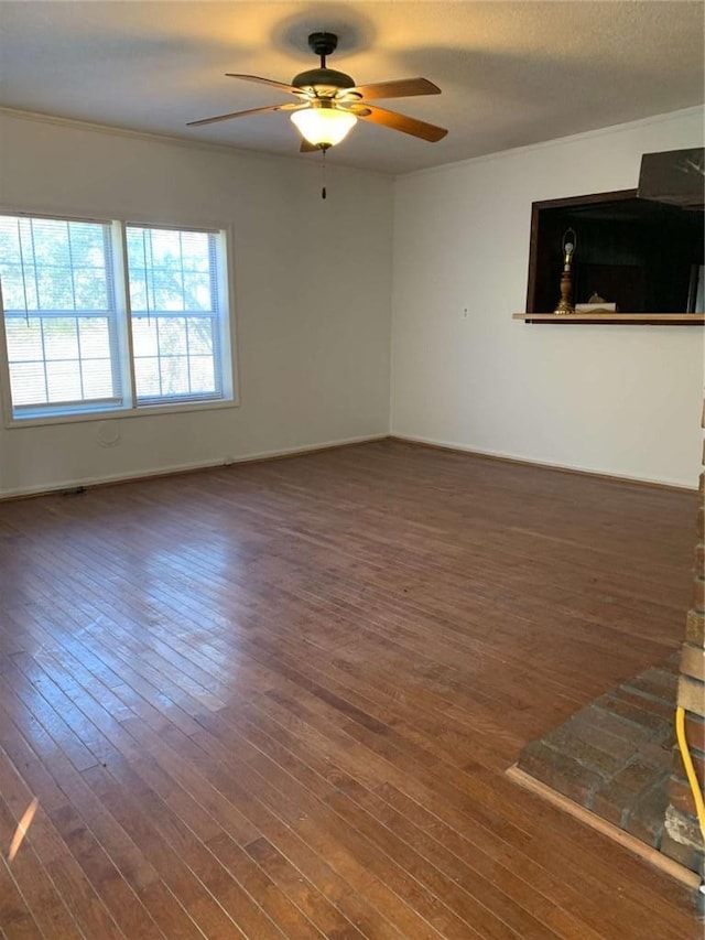 unfurnished room featuring a textured ceiling, hardwood / wood-style flooring, baseboards, and ceiling fan