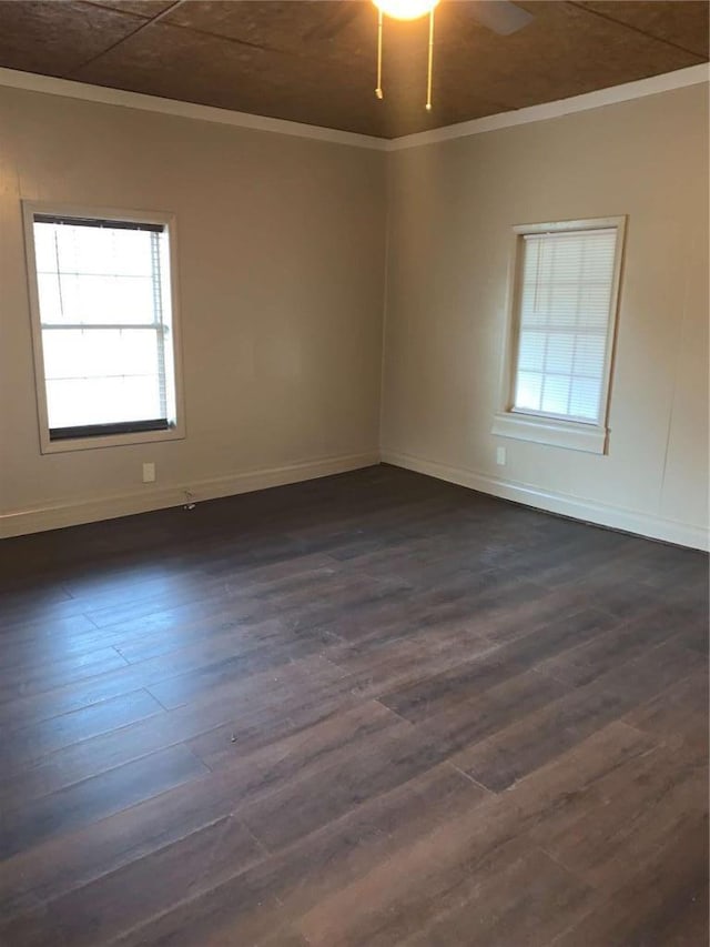 unfurnished room with dark wood-style flooring, baseboards, a ceiling fan, and ornamental molding