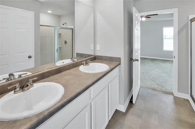 full bath featuring a stall shower, a sink, and double vanity