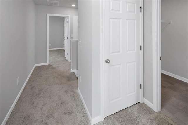corridor with recessed lighting, carpet flooring, visible vents, and baseboards
