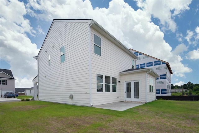 back of property featuring a patio and a yard