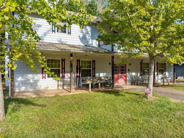 view of front of home with a patio and a front yard