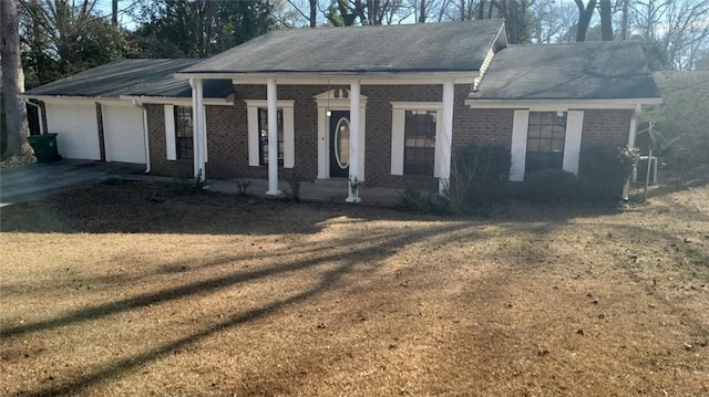 view of front of home with a garage and a front lawn