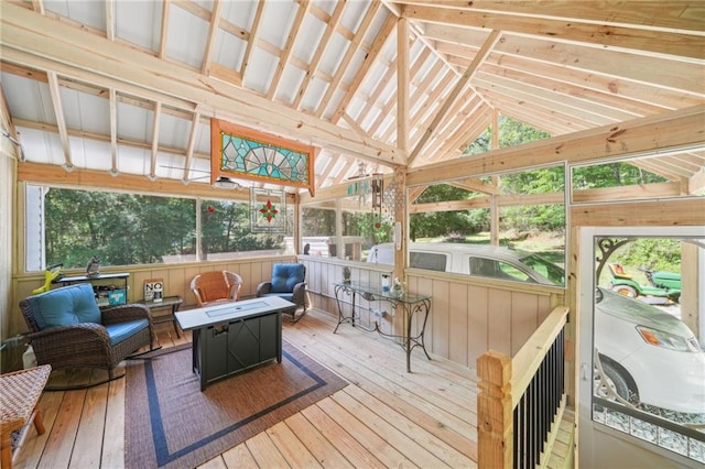 sunroom featuring a fire pit and vaulted ceiling
