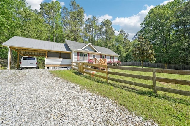 view of front of house with driveway and a carport