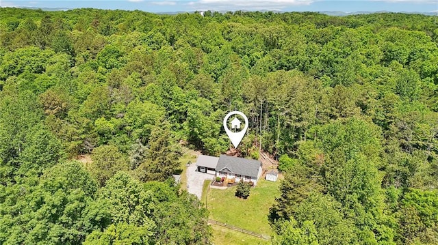 view of subject property featuring a heavily wooded area