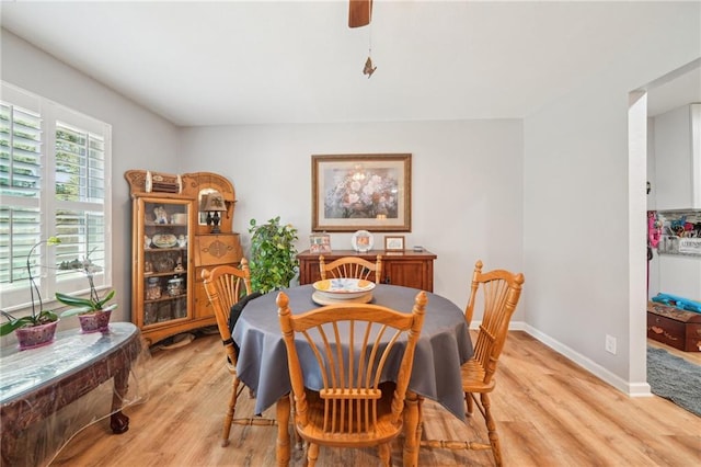 dining area with light wood-style floors and baseboards
