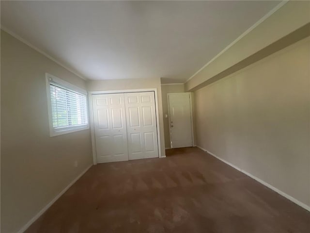 1870 Glen Echo Dr, Decatur, GA 30032 - unfurnished bedroom featuring ornamental molding, dark carpet, and a closet