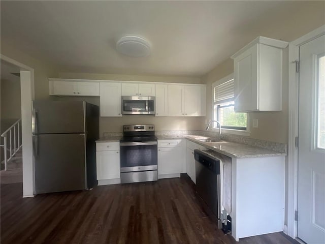 1870 Glen Echo Dr, Decatur, GA 30032 - kitchen featuring white cabinetry, stainless steel appliances, dark hardwood / wood-style floors, and sink