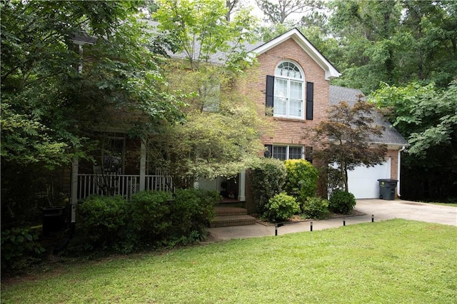 1473 Wildwood Way, Hampton, GA 30228 - colonial house with brick siding, concrete driveway, a front yard, and a garage