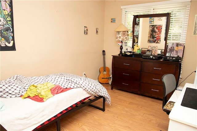 1473 Wildwood Way, Hampton, GA 30228 - bedroom with light wood-style flooring and multiple windows