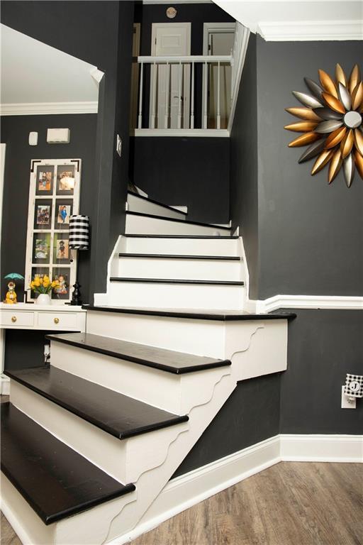 1473 Wildwood Way, Hampton, GA 30228 - stairs with wood finished floors and crown molding