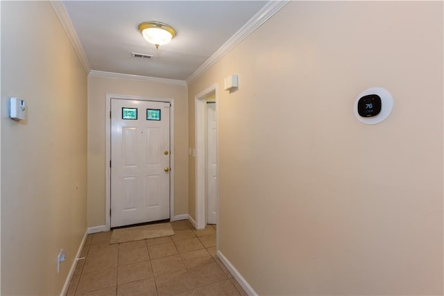 entryway with crown molding and light tile patterned floors