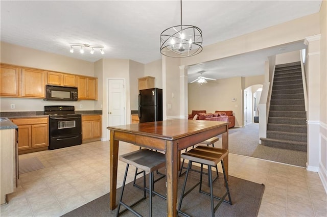 kitchen with pendant lighting, ceiling fan, light carpet, and black appliances