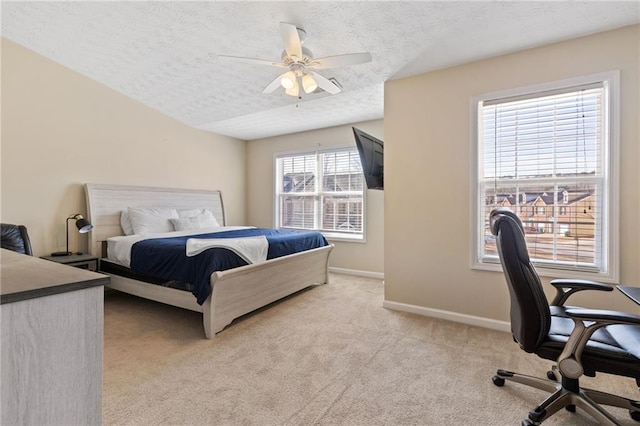 carpeted bedroom featuring multiple windows, ceiling fan, and a textured ceiling