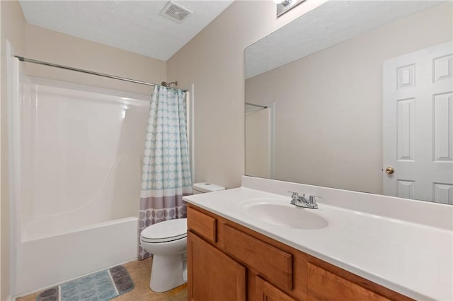 full bathroom featuring tile patterned flooring, vanity, toilet, shower / bathtub combination with curtain, and a textured ceiling