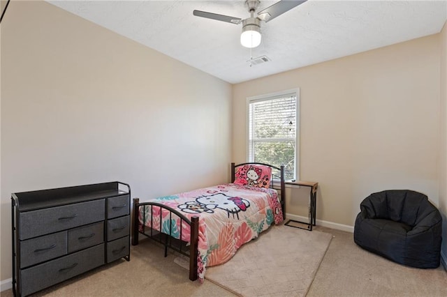 bedroom featuring light carpet and ceiling fan