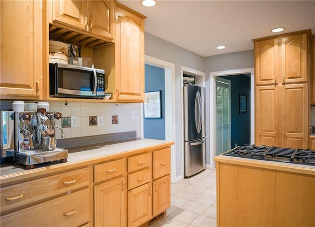 kitchen featuring light tile patterned floors, decorative backsplash, appliances with stainless steel finishes, light countertops, and recessed lighting