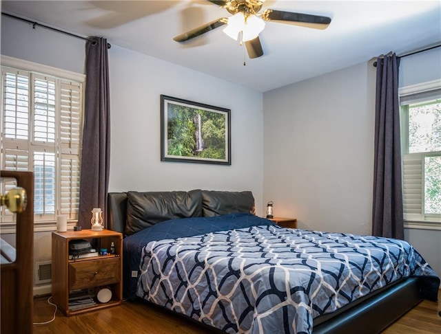 bedroom featuring dark wood-style floors and a ceiling fan