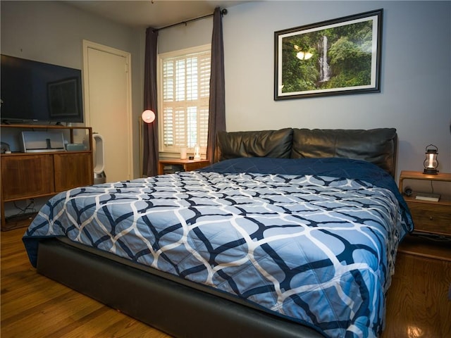 bedroom with wood finished floors