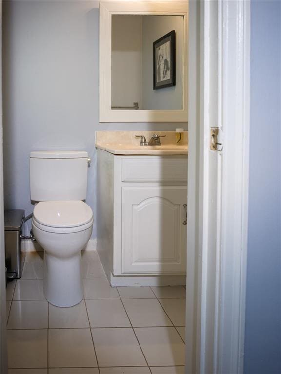 bathroom featuring toilet, vanity, and tile patterned floors