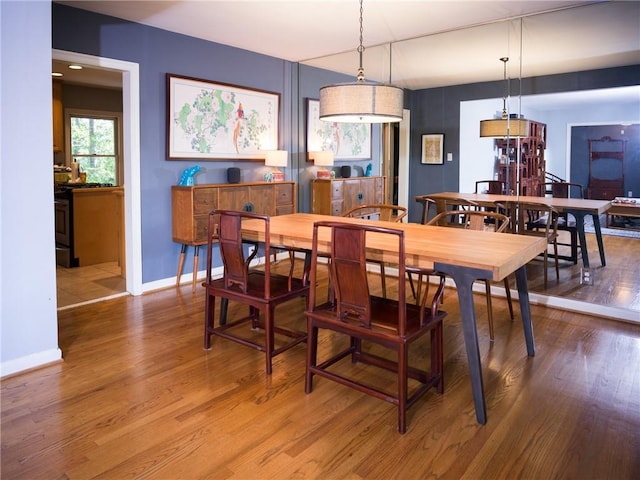 dining area featuring baseboards and wood finished floors