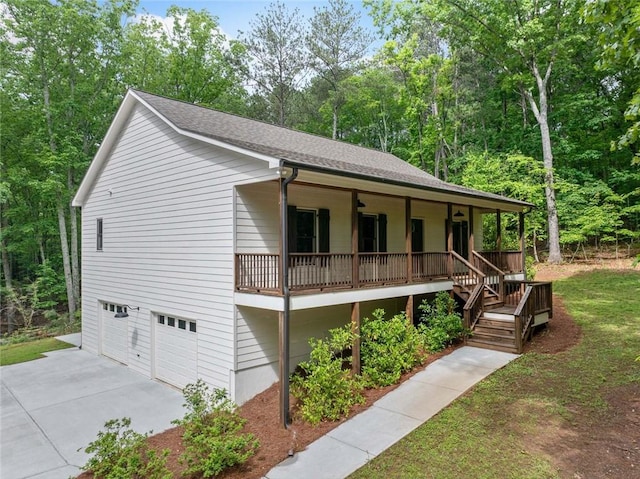 view of front of property with a porch, a garage, concrete driveway, and roof with shingles