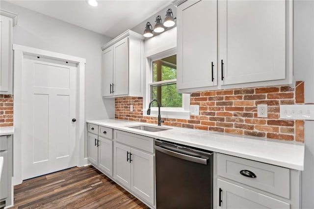 kitchen with dishwasher, a sink, tasteful backsplash, light countertops, and dark wood-style flooring