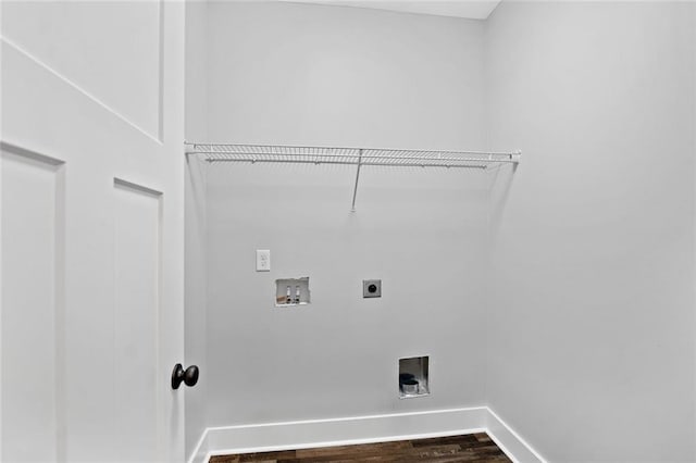 laundry room featuring electric dryer hookup, washer hookup, dark wood-type flooring, and baseboards