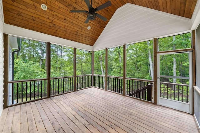 unfurnished sunroom featuring vaulted ceiling, ceiling fan, and plenty of natural light