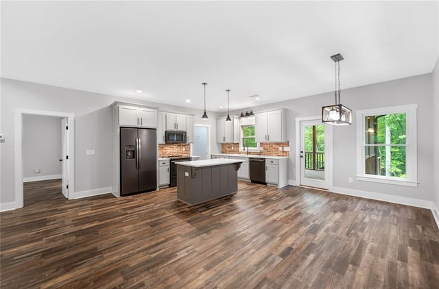 kitchen with appliances with stainless steel finishes, baseboards, light countertops, dark wood-style flooring, and recessed lighting