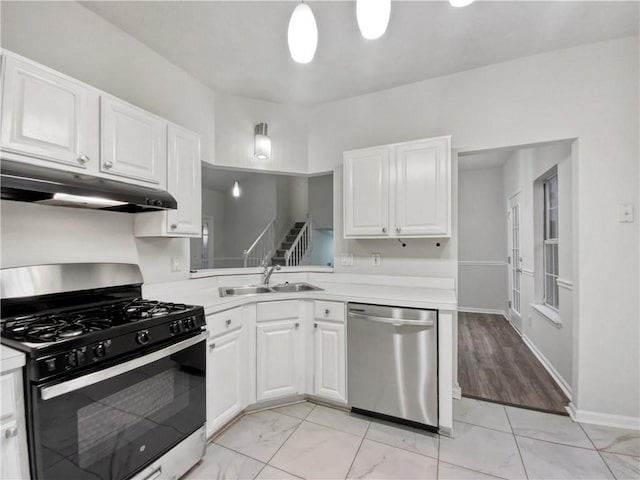 kitchen featuring gas range oven, white cabinets, dishwasher, and sink