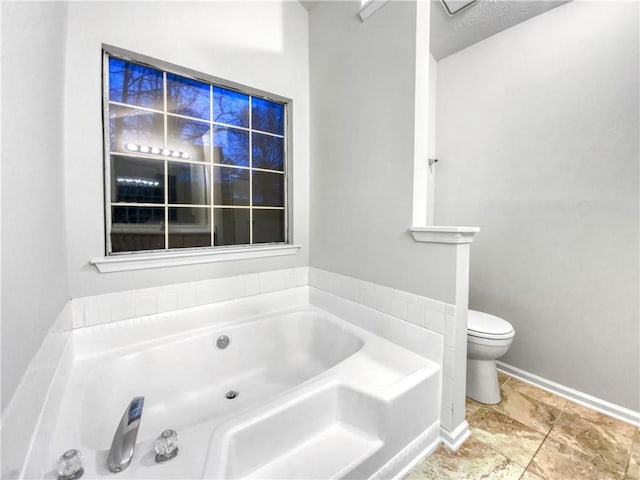 bathroom with toilet and a washtub