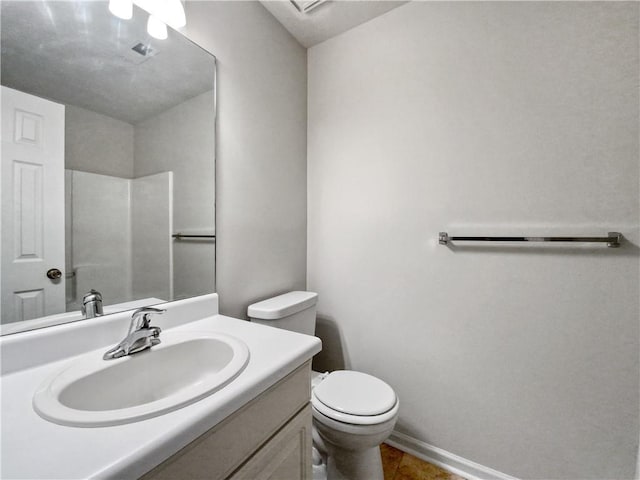 bathroom featuring toilet and vanity