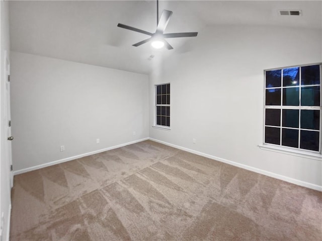 unfurnished room with ceiling fan, vaulted ceiling, and carpet flooring