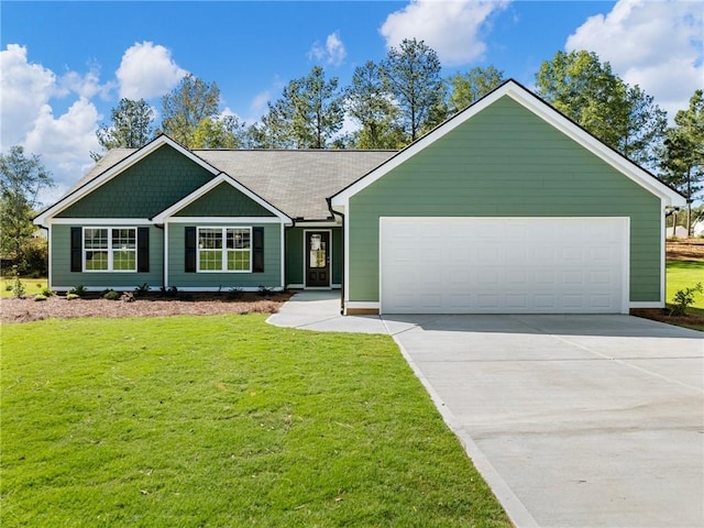 view of front facade with a front yard, concrete driveway, and an attached garage