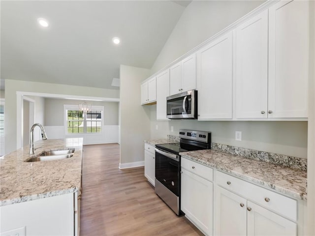 kitchen featuring white cabinets, stainless steel appliances, and a sink