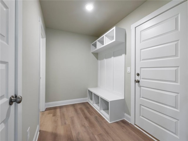 mudroom featuring baseboards and wood finished floors