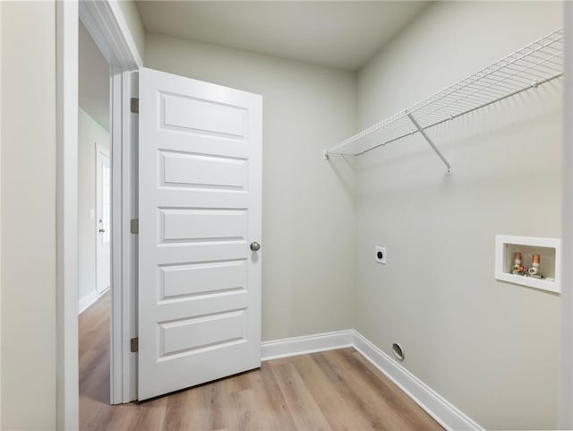 laundry area featuring laundry area, light wood finished floors, baseboards, hookup for an electric dryer, and washer hookup