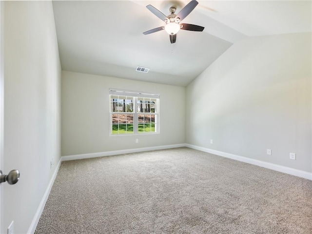 unfurnished room featuring carpet floors, lofted ceiling, visible vents, ceiling fan, and baseboards