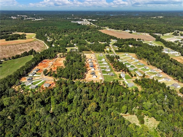 birds eye view of property with a wooded view