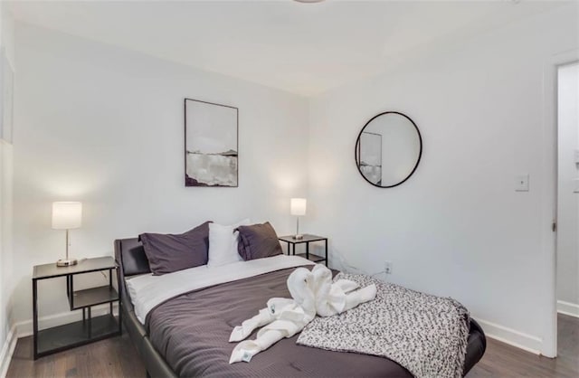 bedroom with dark wood-type flooring