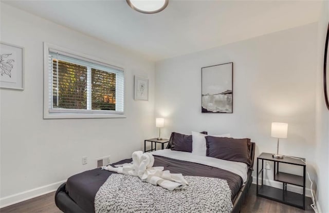 bedroom featuring dark hardwood / wood-style flooring