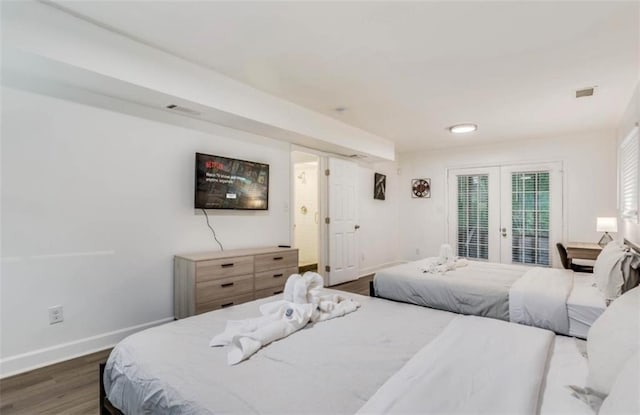 bedroom featuring dark hardwood / wood-style floors, access to outside, and french doors