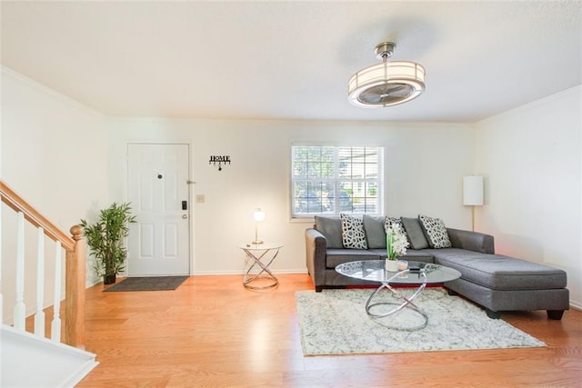 living room featuring wood-type flooring and ornamental molding