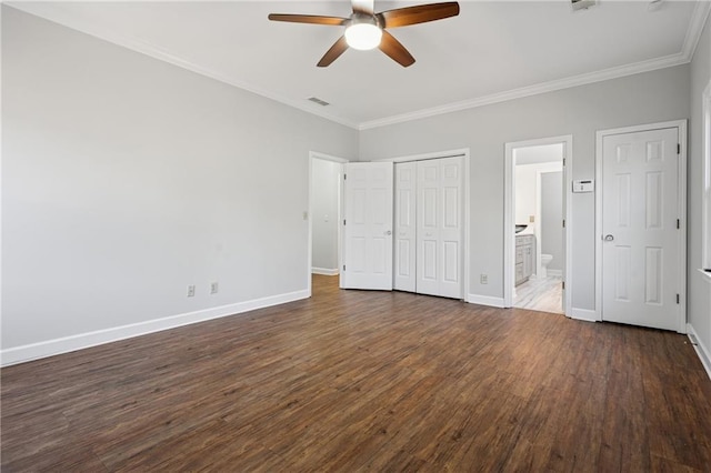 unfurnished bedroom with dark wood finished floors, baseboards, ensuite bathroom, and ornamental molding