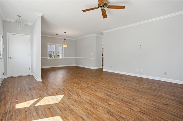 spare room with baseboards, ceiling fan with notable chandelier, wood finished floors, and ornamental molding